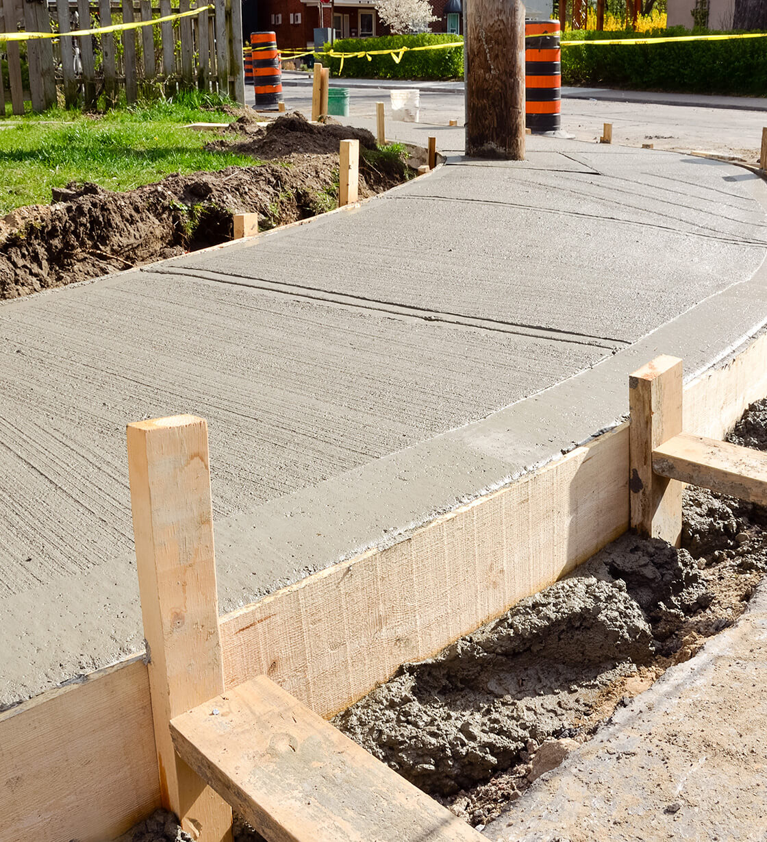Freshly poured and finished concrete driveway by Universal Landscaping